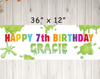 May include: A white banner with green slime dripping down the sides. The banner says "Happy 7th Birthday Gracie" in rainbow letters. The banner is 36 inches by 12 inches.