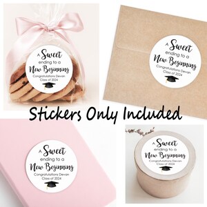May include: Four round white stickers with black text that reads "A Sweet ending to a New Beginning Congratulations Devan Class of 2024" and a black graduation cap with a gold tassel. The stickers are on various surfaces, including a bag of cookies, a brown envelope, a pink surface, and a brown container.