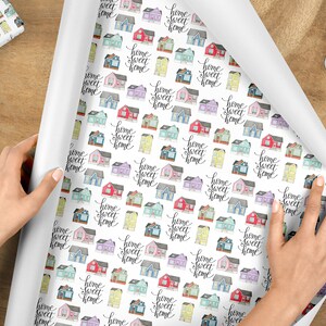 May include: White wrapping paper with a repeating pattern of colorful houses and the text "home sweet home" in black script.