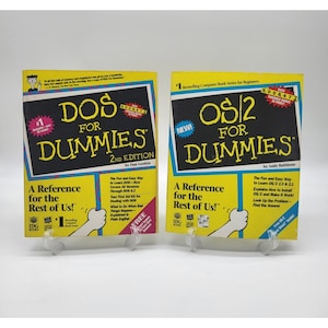 May include: Two yellow and black instructional books titled DOS For Dummies 2nd Edition by Dan Gookin and OS/2 For Dummies by Andy Rathbone. Both covers feature the iconic cartoon character hand, bold yellow text, and IDG Books branding.