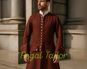 May include: A burgundy-colored coat with gold buttons and a white collar. The coat has long sleeves with decorative cuffs and pockets. The text "Regal Tailor" is visible on the coat. The coat is part of a historical costume.