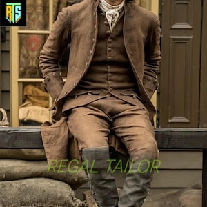 May include: A brown three-piece suit with a long coat, vest, and pants. The suit is made of a textured fabric and has a classic style. The model is wearing black boots.