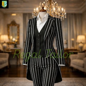 May include: A black and white striped suit, consisting of a blazer, vest, and trousers, is displayed on a mannequin. The blazer and trousers feature vertical white stripes. A white collared shirt is visible beneath the vest. The suit is tailored and formal.