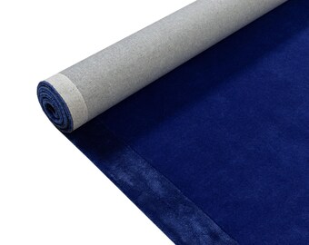 May include: A roll of dark blue fabric with a gray backing. The fabric is rolled up and the backing is visible.