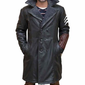 May include: Black double-breasted leather coat with a shearling collar and lining. Features include a brown elbow patch, white stripes on the upper sleeve, and two front pockets. A stylish outerwear garment.