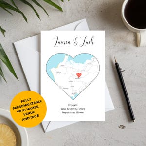 May include: A white card with a heart-shaped map, featuring the names "Lauren & Lach." The card includes the text "Engaged," the date "22nd September 2025," and the location "Reynoldston, Gower." A yellow circle states "FULLY PERSONALIZABLE WITH NAMES, VENUE AND DATE."