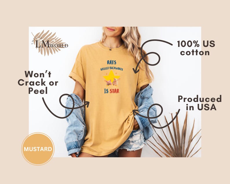 May include: Mustard-colored t-shirt with the text "RATS SPELLED BACKWARDS IS STAR" in a playful font, featuring a star graphic. The shirt is made of 100% US cotton and produced in the USA. The design is printed with a won't crack or peel guarantee.