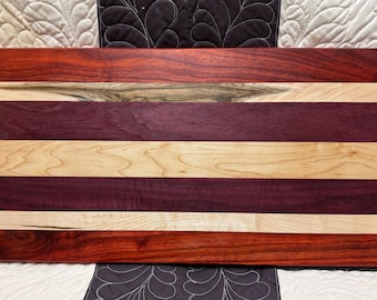 Personalized, handcrafted, high end charcuterie board. Thick, solid wood made of Padauk, Purple Heart, and Ambrosia Maple chopping block.