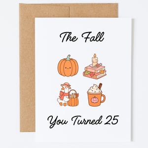 May include: A white greeting card with a brown envelope featuring the text The Fall You Turned 25. The design includes a smiling orange pumpkin, a candle on stacked books, a goose wearing a hat and scarf with a basket, and a mug of hot cocoa.