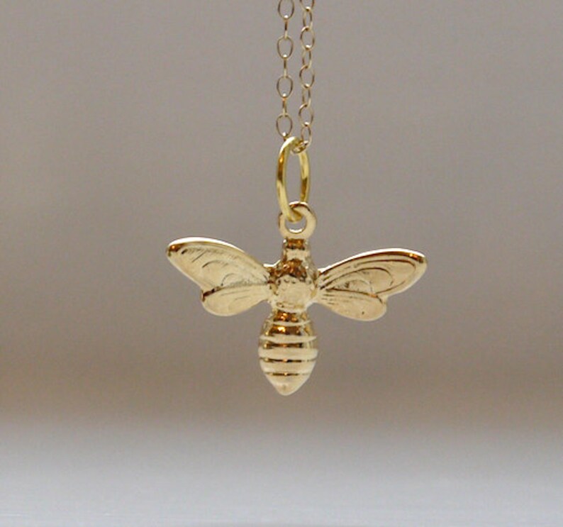 Tiny bee necklace in gold image 1