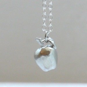 Apple with silver necklace image 1