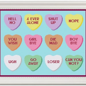 May include: A set of 12 heart-shaped candy conversation hearts with various sarcastic and humorous messages, such as "Hell No", "4 Ever Alone", "Shut Up", "Nope", "You Wish", "Girl Bye", "Die Mad", "Boy Bye", "Ugh", "Go Away", "Loser", and "Can You Not?"