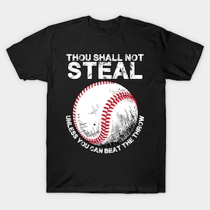 May include: Black t-shirt with a baseball graphic. The baseball is white with red stitching and a stylized design. The text reads "THOU SHALL NOT STEAL" above the baseball and "UNLESS YOU CAN BEAT THE THROW" below.