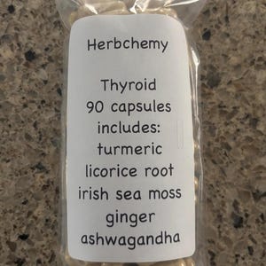 May include: A clear plastic bag filled with light brown capsules. A white label reads "Herbchemy Thyroid 90 capsules includes: turmeric, licorice root, irish sea moss, ginger, ashwagandha."