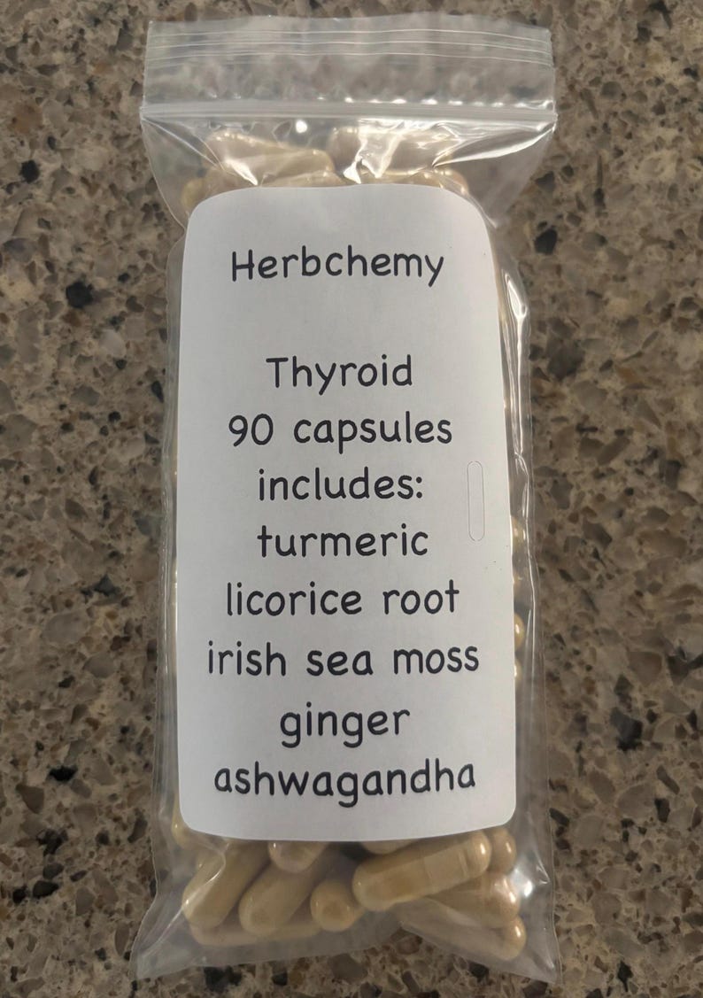 May include: A clear plastic bag filled with light brown capsules. A white label reads "Herbchemy Thyroid 90 capsules includes: turmeric, licorice root, irish sea moss, ginger, ashwagandha."