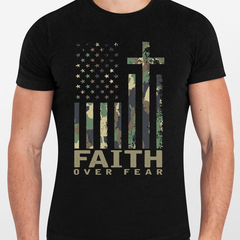 May include: Black t-shirt featuring a distressed American flag design with a cross and camouflage stripes. The words "FAITH OVER FEAR" are printed in a bold, sans-serif font below the flag.
