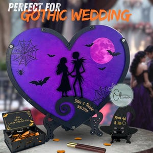 May include: A heart-shaped gothic wedding guest book with a purple background, Jack and Sally silhouettes, and a full moon. Includes a matching pen, a small box, and a hat-shaped sign holder. The text reads "Perfect for Gothic Wedding".