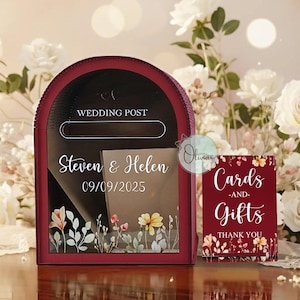 May include: A burgundy wedding post box with a slot for cards, personalised with "Steven & Helen" and the date "09/09/2025". A matching sign reads "Cards -and- Gifts THANK YOU". Floral accents adorn the box and sign.