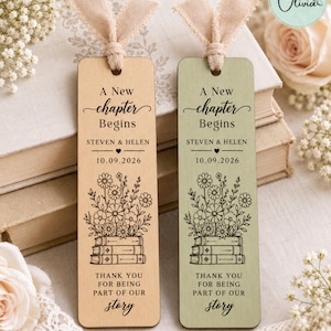May include: Two rectangular wooden bookmarks with beige ribbon ties. One is light wood, the other sage green. Both feature the text A New Chapter Begins, Steven & Helen, 10.09.2026, a floral illustration on stacked books, and Thank You For Being Part Of Our Story.