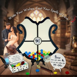 May include: A decorative wedding guest book alternative with a shield-shaped frame, featuring a 9 3/4 design. The frame is surrounded by colorful wish tokens. The text reads "Write Your Wishes, Cast Your Spells of Love".