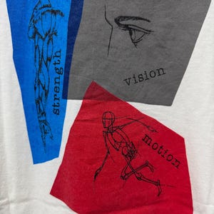 May include: White t-shirt with graphic design elements. Features a blue rectangle with a muscle illustration and the word "strength." A gray rectangle displays an eye drawing and the word "vision." A red rectangle shows a running figure and the word "motion."