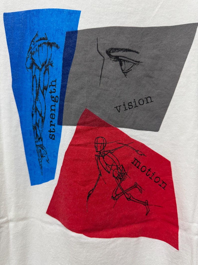 May include: White t-shirt with graphic design elements. Features a blue rectangle with a muscle illustration and the word "strength." A gray rectangle displays an eye drawing and the word "vision." A red rectangle shows a running figure and the word "motion."