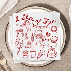 May include: White paper napkins with a red birthday-themed design. The napkins feature illustrations of pizza, balloons, a cake, and the text "A Slice of Fun" and "Kevin's 1st Birthday". The napkins are on a white plate.