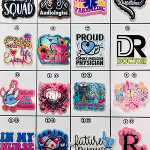 May include: A collection of sixteen colorful medical-themed charms with various designs and text, including "Audiology Squad," "Paramedic," "CNA," "Doctor," and "Nurse." The charms feature glitter and vibrant colors.