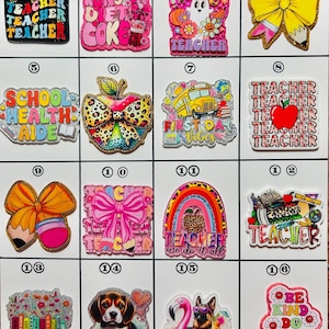 May include: A collection of colorful teacher-themed charms. Designs include a ghost, school bus, apple, bow, rainbow, books, and a dog. Each charm has text such as "Teacher", "First Day Vibes", and "Be Kind Do Good Things".