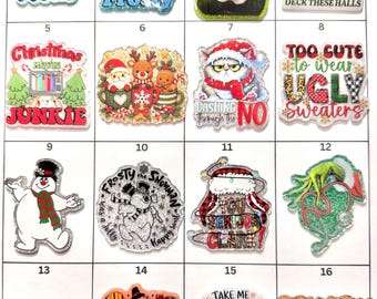 May include: A collection of sixteen rectangular acrylic charms featuring various holiday-themed illustrations and text, including characters like Frosty the Snowman, Buddy the Elf, and the Grinch, alongside seasonal phrases like Fall Vibes and Christmas Movie Junkie.