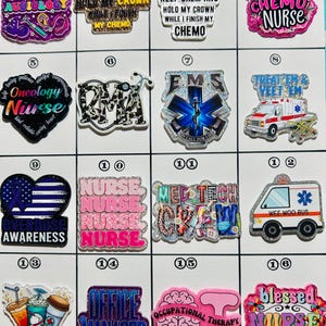 May include: A collection of colorful, glittery pins with various medical and healthcare-related themes. Designs include "Audiology," "Chemo Nurse," "EMS," "Nurse," and "Office Manager," among others. Each pin features bold text and vibrant graphics.