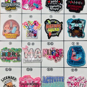 May include: A collection of colorful, glittery badge reels with various medical and cleaning-related themes. Designs include text like "Housekeeping Squad," "Respiratory Therapist," and "Dietary Squad." The badges are in various shapes.