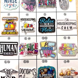 May include: A collection of colorful, glittery pins with various profession-themed designs. The pins feature text such as "NURSE", "HOUSEKEEPING", "OFFICE LIFE", and "POSTAL WORKER". Other designs include medical symbols and butterflies.