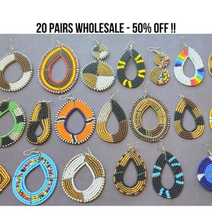 May include: A collection of twenty pairs of beaded earrings in various shapes and colors. Designs include teardrops, hoops, and geometric shapes, with colors like black, white, yellow, blue, and green. The earrings are displayed on a gray surface.