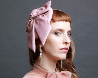 Pink velvet fascinator hat with oversized statement bow and vintage diamanté buckle