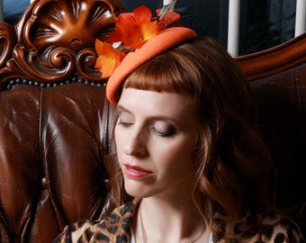 Orange felt small round hat with flame coloured feather flowers, bright wedding or Ascot fascinator