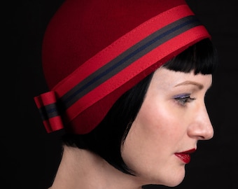 Red felt tight fitting 1920s style cloche hat with striped ribbon bow