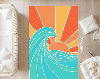 May include: A rectangular rug featuring a retro sunset design with a large turquoise wave. The sun is depicted in orange and yellow hues, with rays emanating from behind the wave. The rug has the text "MESGFTURG" on the right side.