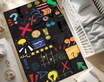 May include: A black rectangular rug with colorful graphic designs, including question marks, arrows, exclamation points, and stars. The rug has a playful, hand-drawn aesthetic, suitable for a child's room or a creative space.