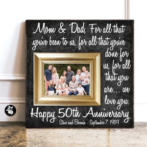 May include: A black and gold picture frame with a photo of a family. The frame has a white inscription that reads "Mom & Dad, For all that you've been to us, for all that you've done for us, for all that you are... we love you. Happy 50th Anniversary Steve and Bonnie - September 7, 1969".