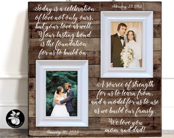 May include: A rustic wooden frame with two white picture frames. The top frame shows a wedding photo from February 28, 1982. The bottom frame shows a wedding photo from January 30, 2022. The text reads: "Today is a celebration of love not only ours, but your love as well. Your lasting bond is the foundation for us to build on. A source of strength for us to learn from, and a model for us to use as we build our family. We love you mom and dad!"