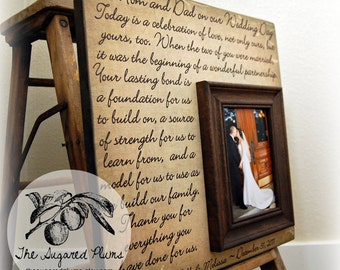 May include: A wooden picture frame with a message to parents on their wedding day. The message reads "To Mom and Dad on our Wedding Day Today is a celebration of love, not only ours, but yours, too. When the two of you were married, it was the beginning of a wonderful partnership. Your lasting bond is a foundation for us to build on, a source of strength for us to learn from, and a model for us to use as we build our family. Thank you for everything you have done for us. Love, Will & Melissa ~ December 31, 2017".
