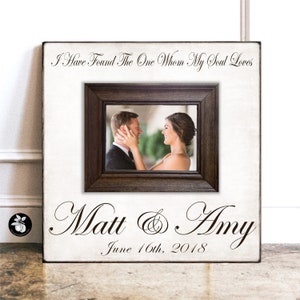 May include: A white wooden sign with a brown frame and a photo of a couple. The sign says "I Have Found The One Whom My Soul Loves" and "Matt & Amy" with the date "June 16th, 2018".
