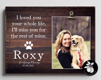 May include: A wooden memorial plaque with a photo of a woman and her dog. The plaque has the text "I loved you your whole life. I'll miss you for the rest of mine." and the dog's name "Roxy" with the date "07.04.2021".