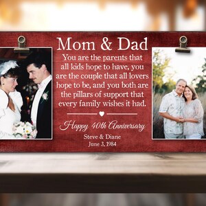 Peut inclure: Une plaque en bois rouge avec une bordure blanche et un message célébrant un 40e anniversaire. La plaque présente deux photos de couples, l'une en noir et blanc et l'autre en couleur. Le texte dit "Maman et Papa Vous êtes les parents que tous les enfants espèrent avoir, vous êtes le couple que tous les amoureux espèrent être, et vous êtes tous les deux les piliers de soutien que chaque famille souhaite avoir. Joyeux 40e anniversaire Steve & Diane 3 juin 1984"