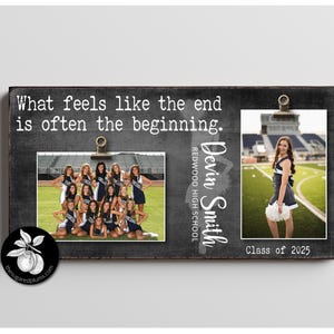 May include: A black chalkboard sign with the text "What feels like the end is often the beginning."  Two photos are attached to the sign with clips. The top photo shows a young woman in a cheerleading uniform standing on a football field. The bottom photo shows a group of cheerleaders in uniform standing in front of a bleacher. The text "Devin Smith" and "Redwood High School" is written on the sign. The text "Class of 2025" is written below the top photo.