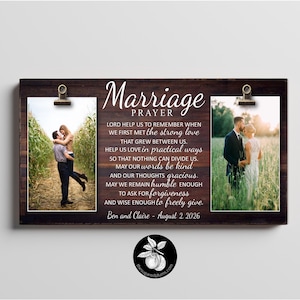 May include: A rectangular dark wood wall plaque featuring the text Marriage Prayer, two metal clips holding vertical photographs of a couple, and the names Ben and Claire with the date August 2 2026 printed in white script at the bottom.