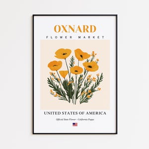 May include: A framed art print featuring a floral illustration of California poppies. The artwork has a cream-colored background with the text "OXNARD FLOWER MARKET" at the top and "UNITED STATES OF AMERICA" at the bottom. The official state flower is also noted.