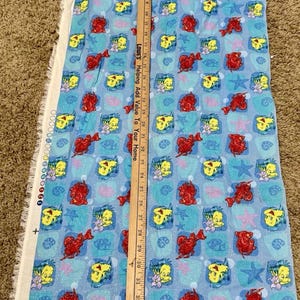 The Little Mermaid fabric piece. 1990’s Vintage main color blue, with images of Sebastian and Flounder and touches of glitter. In great sape