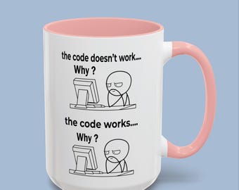 May include: A white ceramic mug with a soft pink interior and handle. The mug features two black line-art illustrations of a person at a computer with the text: the code doesn't work.... Why? and the code works.... Why?
